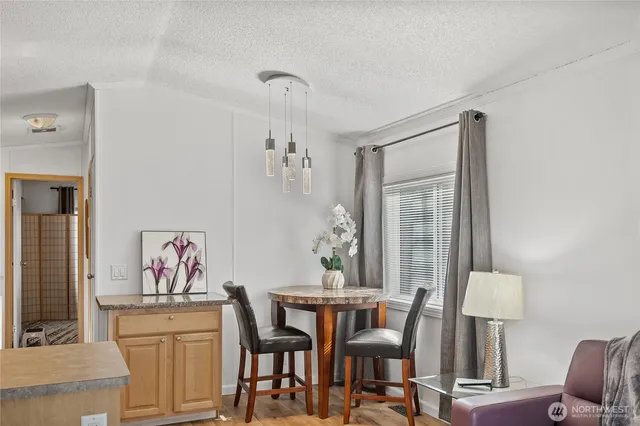 a view of a dining room with furniture and a potted plant