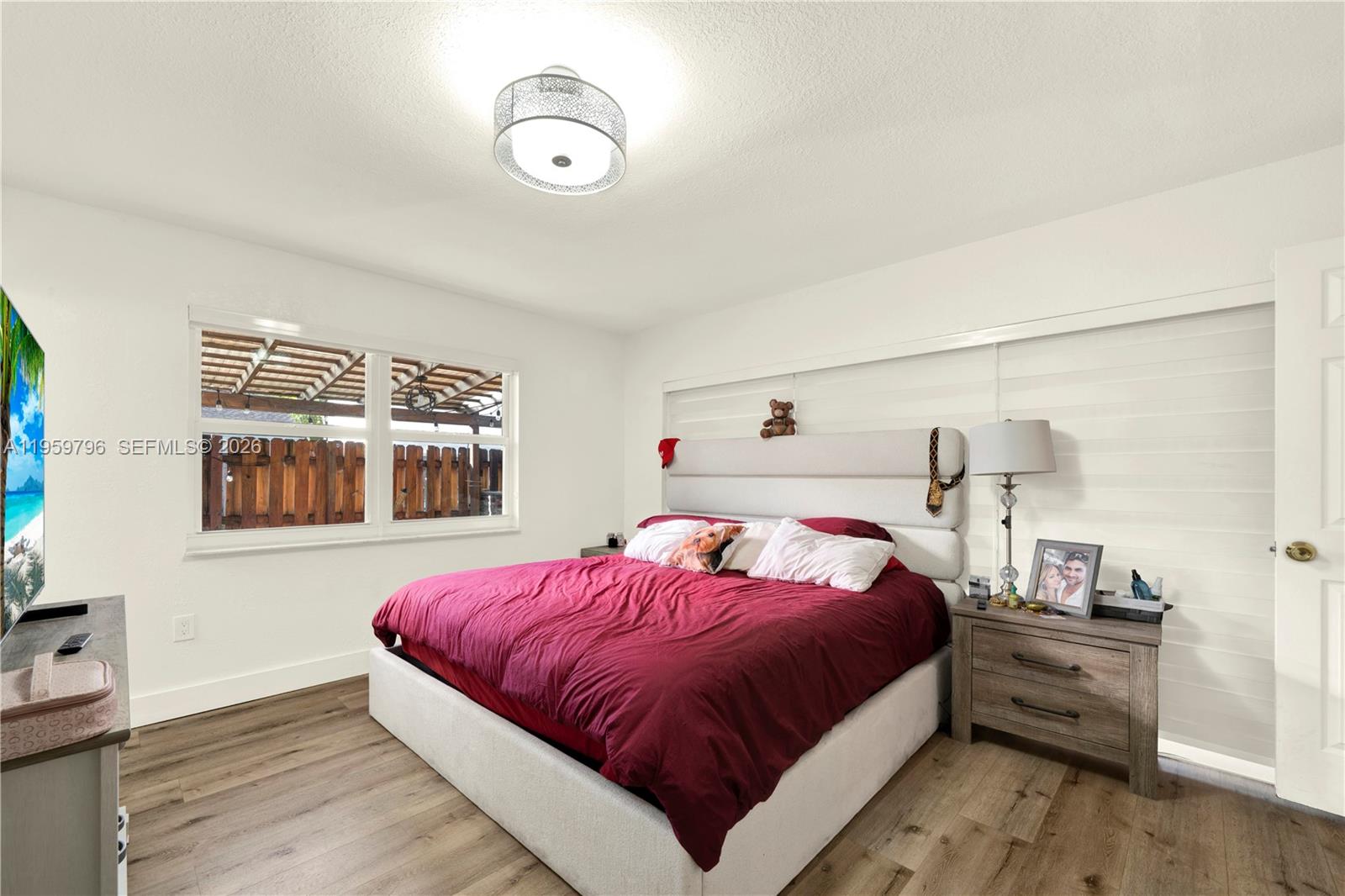 14600 Southwest 124th Place Miami, FL 33186 - Photo 13 of 34 a bedroom with a bed and a chandelier