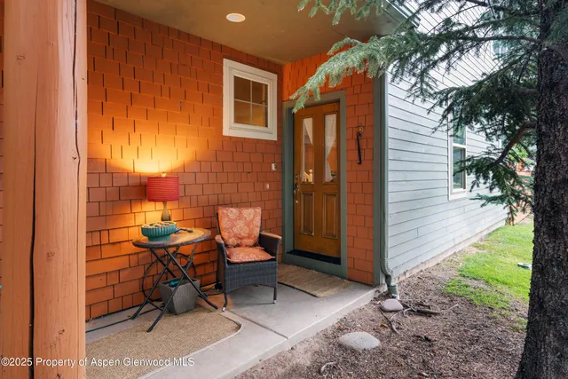 a view of a patio with couches table and chairs and potted plants