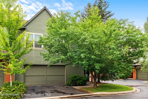 a backyard of a house with outdoor seating