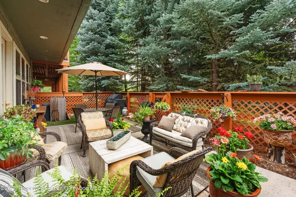 an outdoor space with patio furniture and potted plants