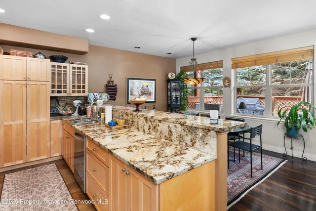 a kitchen with stainless steel appliances granite countertop sink stove top oven and cabinets