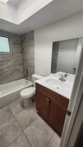 a large kitchen with a stove a sink a microwave and cabinets