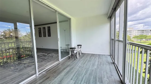 a view of a hallway with wooden floor and fence