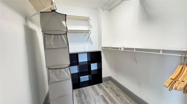 a view of walk in closet with empty racks
