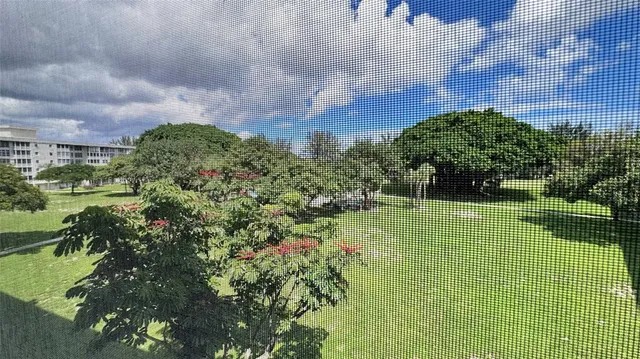 a view of a swimming pool with a yard