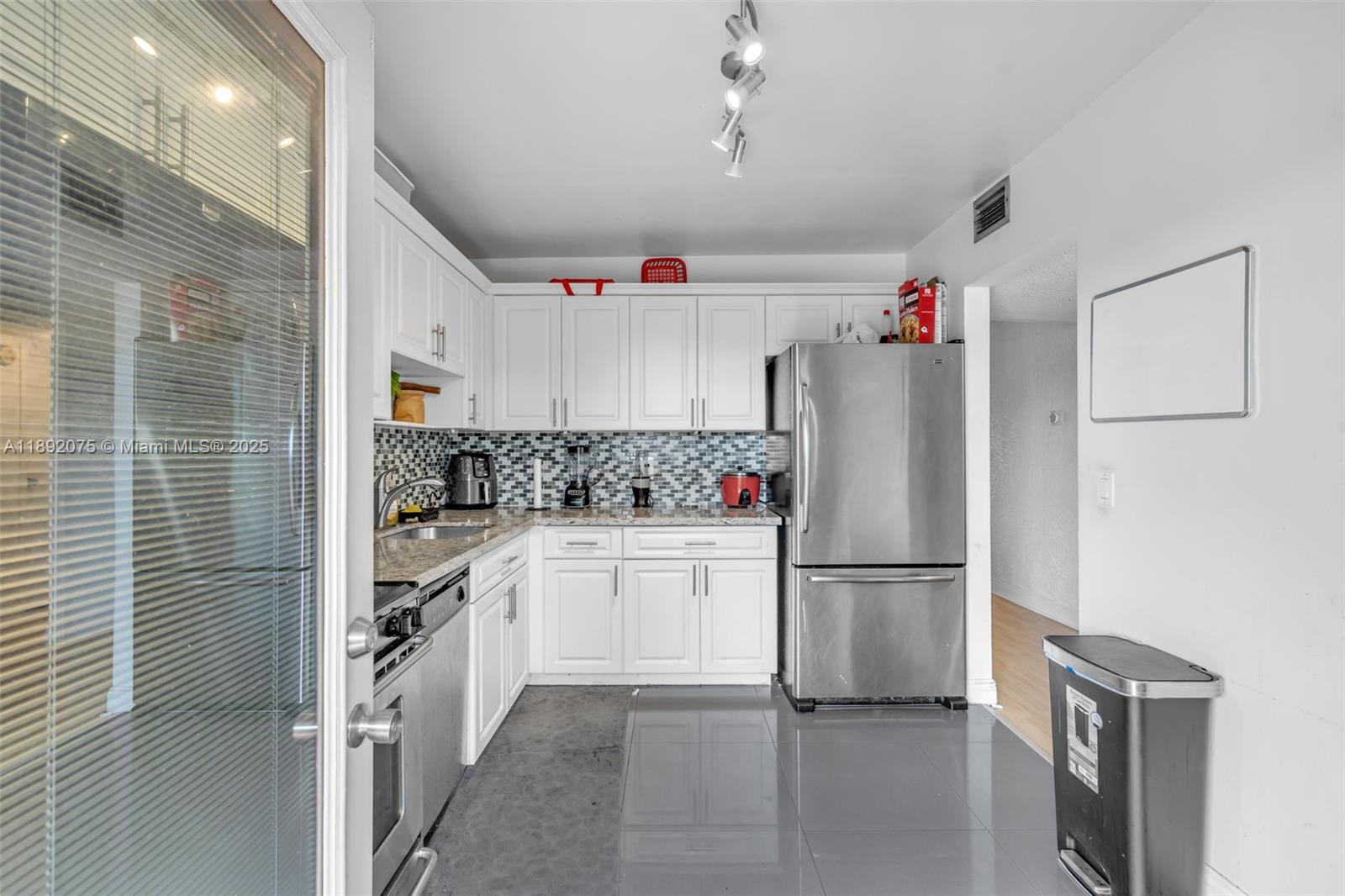 6100 South Falls Cir Drive, Unit 410 Lauderhill, FL 33319 - Photo 12 of 39 a kitchen with refrigerator and cabinets