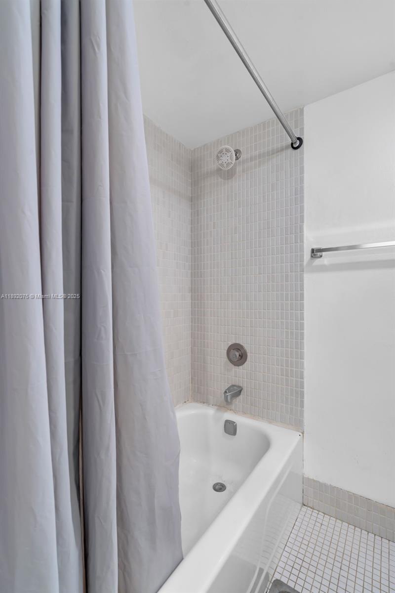 6100 South Falls Cir Drive, Unit 410 Lauderhill, FL 33319 - Photo 16 of 39 a bathroom with a tub a sink and a shower