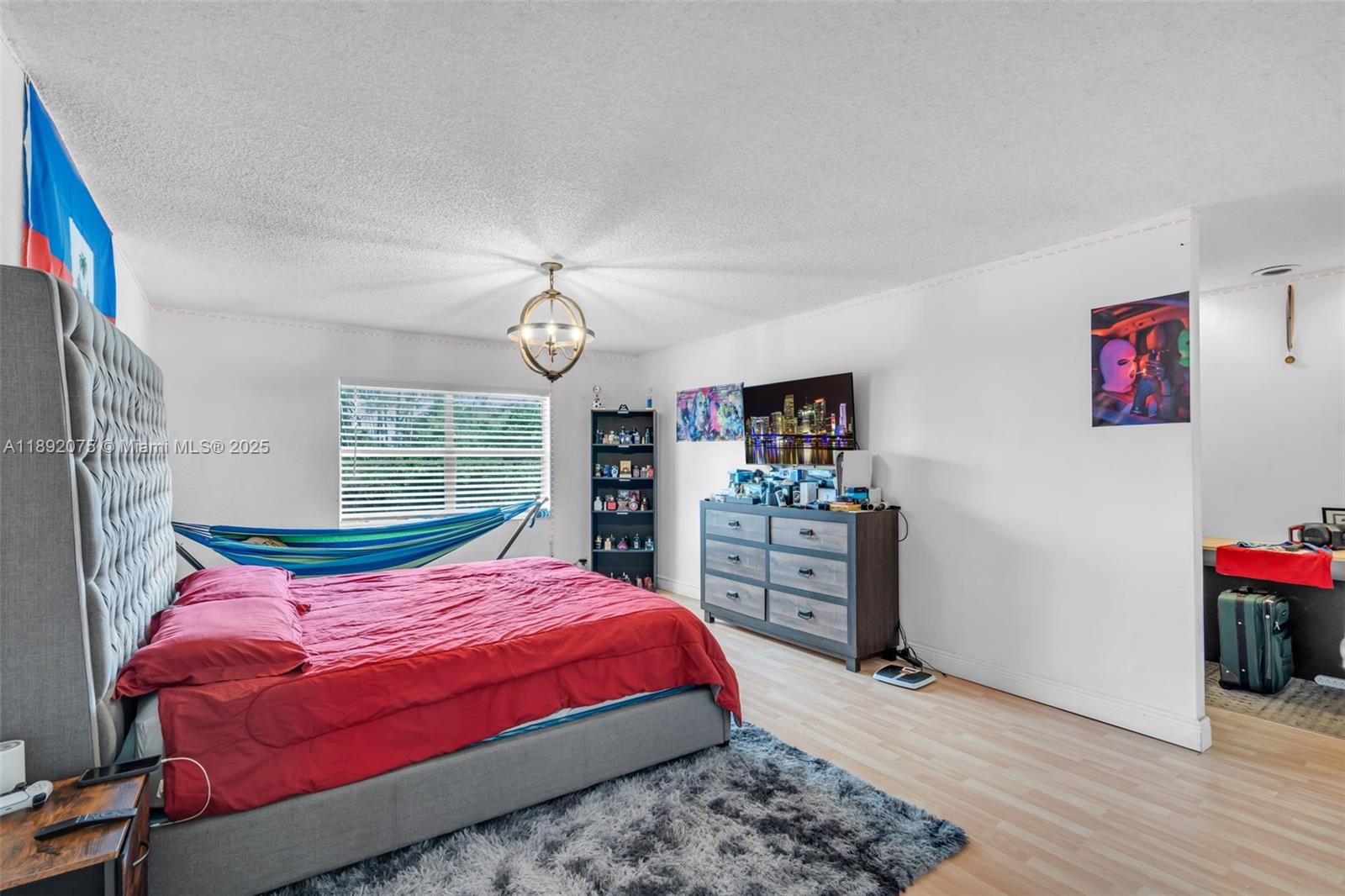 6100 South Falls Cir Drive, Unit 410 Lauderhill, FL 33319 - Photo 17 of 39 a bedroom with a bed and a dresser