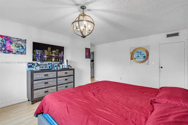 a bedroom with a bed and a dresser in it