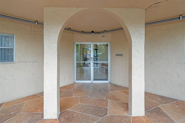 a view of a hallway to rooms