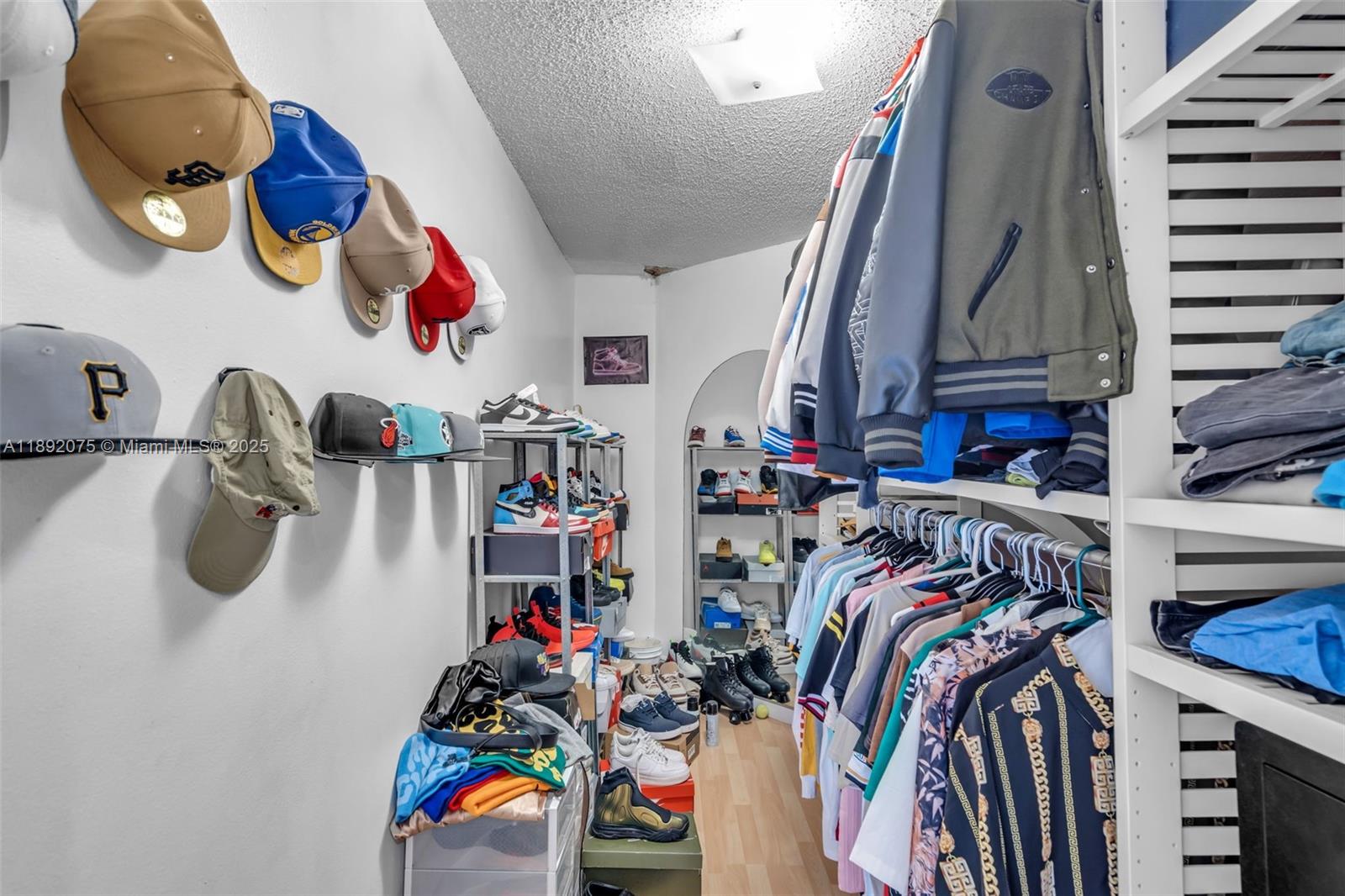 6100 South Falls Cir Drive, Unit 410 Lauderhill, FL 33319 - Photo 22 of 39 a view of walk in closet with clothes and shoes