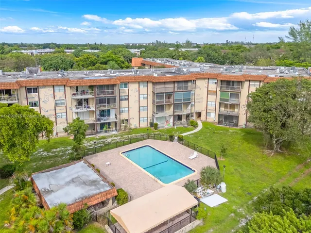 a view of a house with pool and a yard
