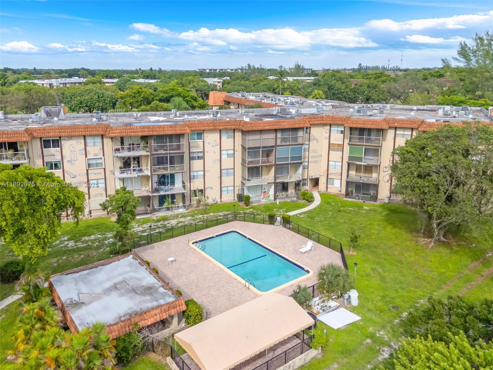6100 South Falls Cir Drive, Unit 410 Lauderhill, FL 33319 - Photo 38 of 39 a view of a house with pool and a yard