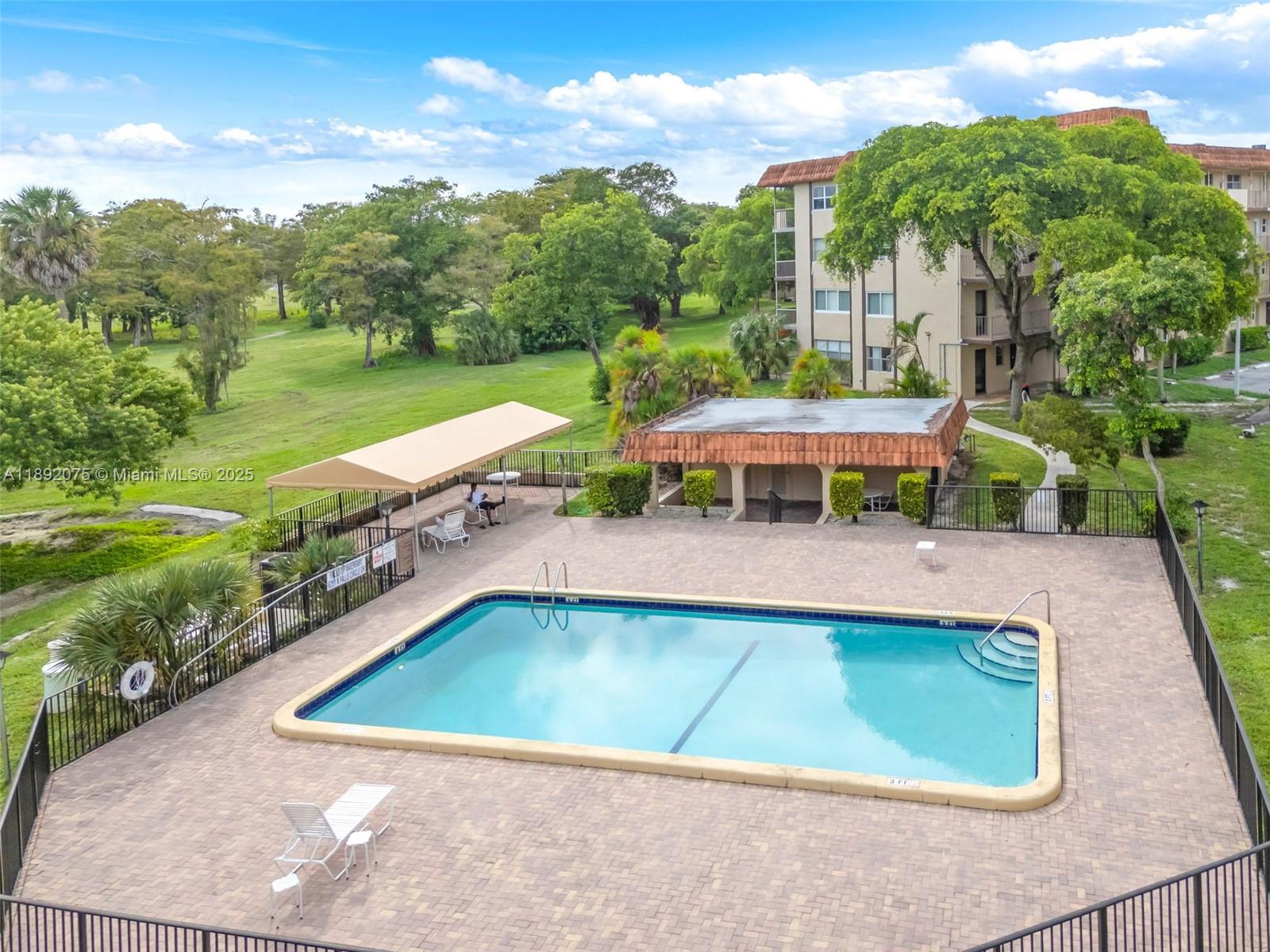 6100 South Falls Cir Drive, Unit 410 Lauderhill, FL 33319 - Photo 39 of 39 a view of a swimming pool and a yard
