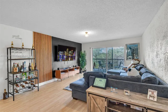 a living room with furniture and a floor to ceiling window