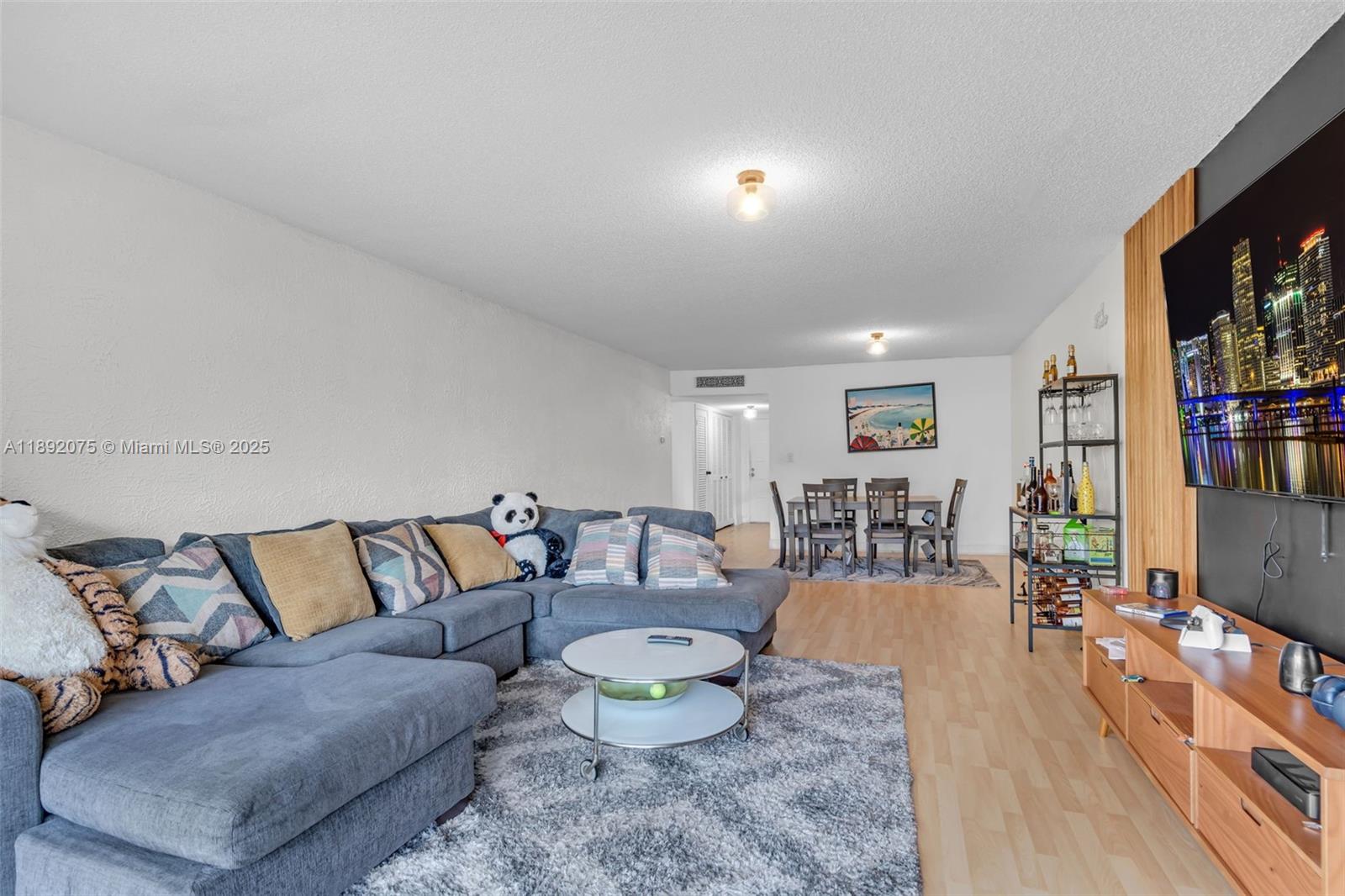 6100 South Falls Cir Drive, Unit 410 Lauderhill, FL 33319 - Photo 9 of 39 a living room with furniture and a flat screen tv
