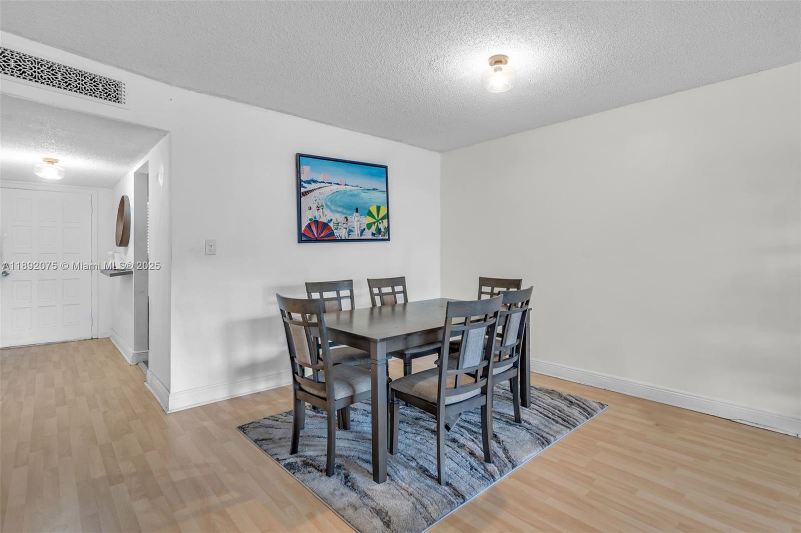 6100 South Falls Cir Drive, Unit 410 Lauderhill, FL 33319 - Photo 10 of 39 a view of a dining room with furniture and wooden floor