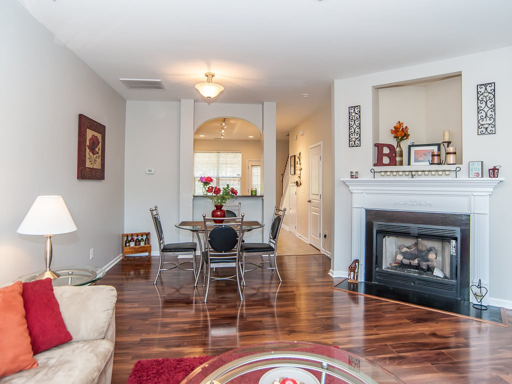 4815 Sir Duncan Way Raleigh, NC 27612 - Photo 5 of 25 Enjoy the gas fireplace in the living room while still feeling connected to the kitchen. Living Room/Dining Area