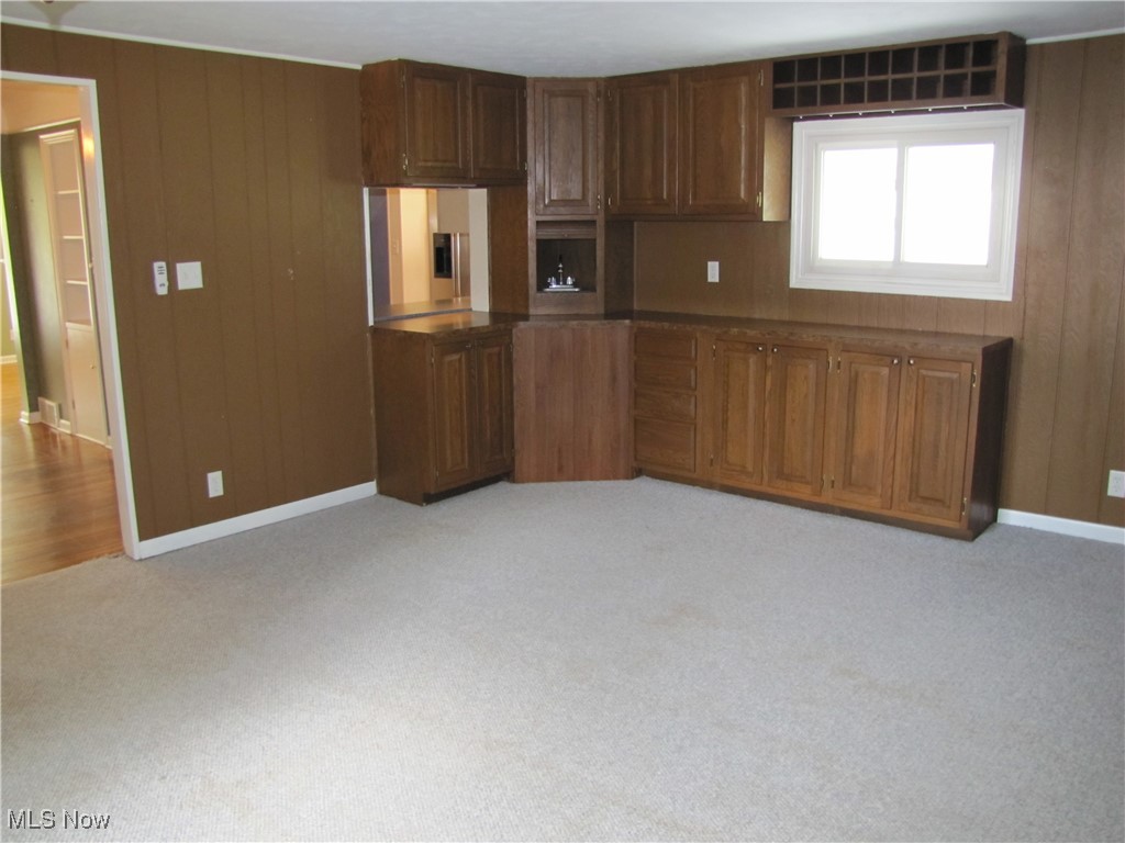 1194 Croyden Road Lyndhurst, OH 44124 - Photo 16 of 25 Kitchen with wooden walls, dark countertops, and light carpet