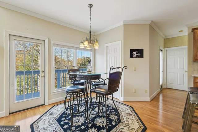 a living room with a table chairs and a window