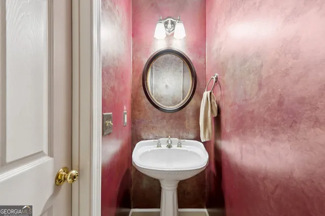 a bathroom with a granite countertop sink a mirror and a shower