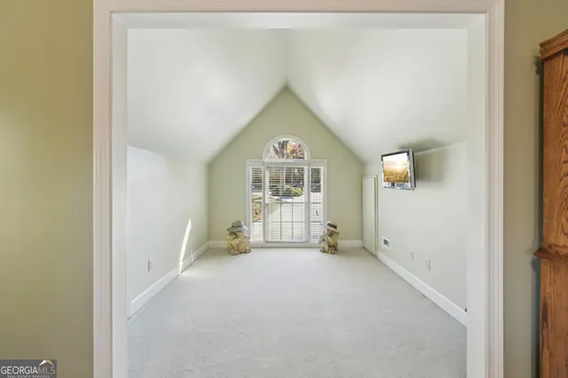 a view of backyard with a barn and large trees