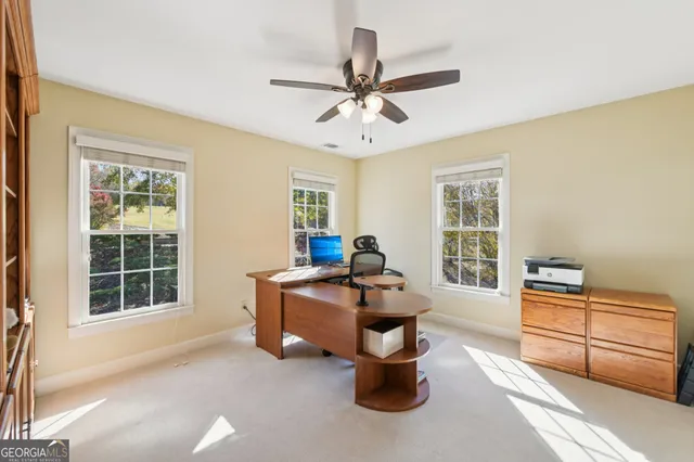an aerial view of a house with a yard and mountain view in back