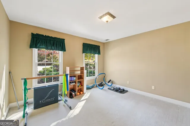 a view of a house with a yard and potted plants