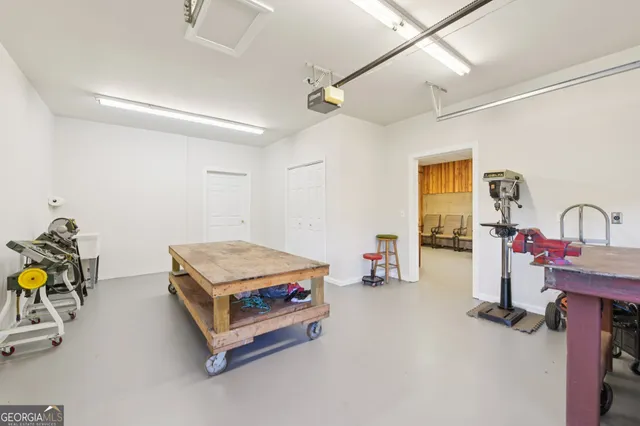 a view of a big house with plants and large trees
