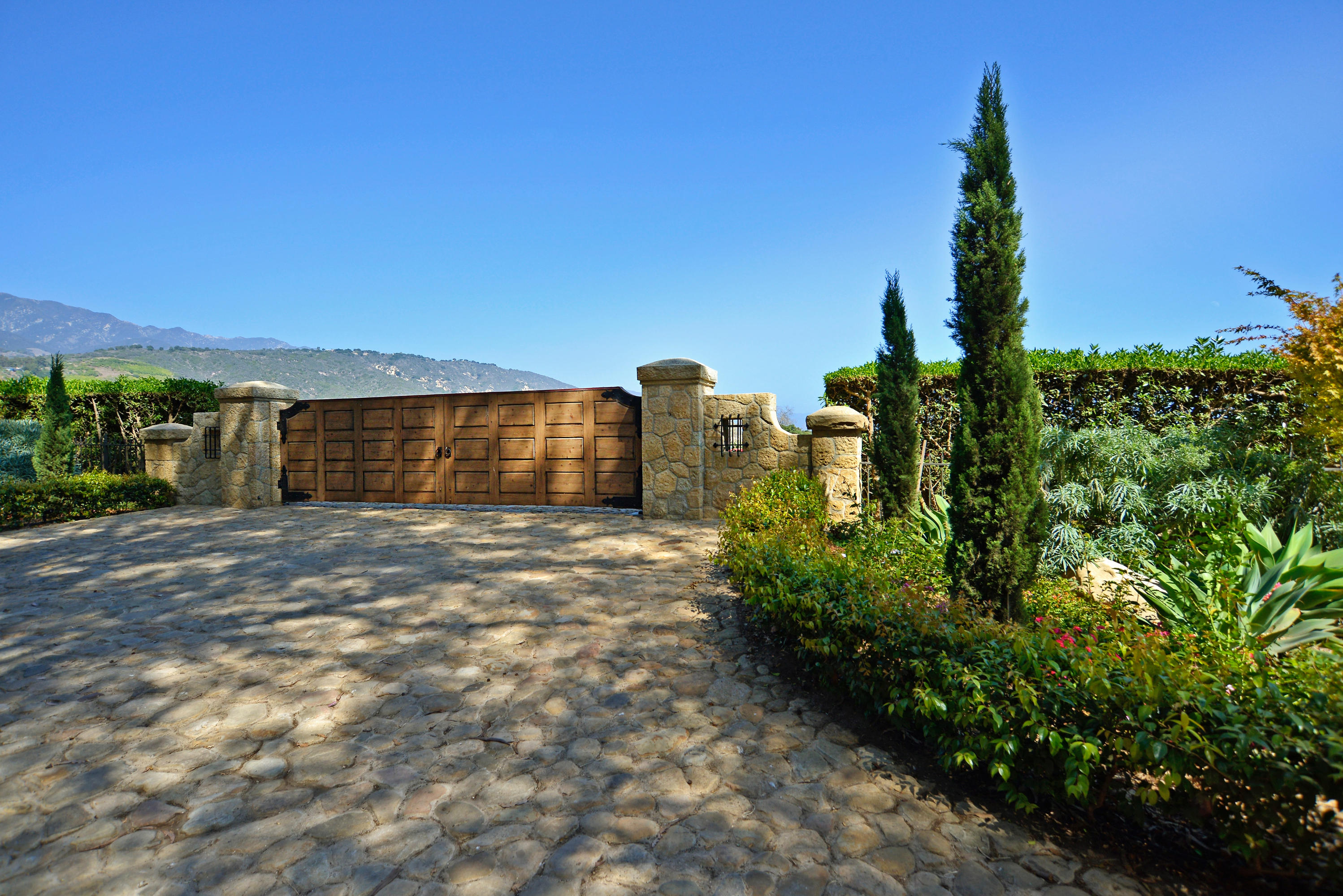 200 Lambert Road Carpinteria, CA 93013 - Photo 1 of 25 a front view of a house with a yard and mountain view