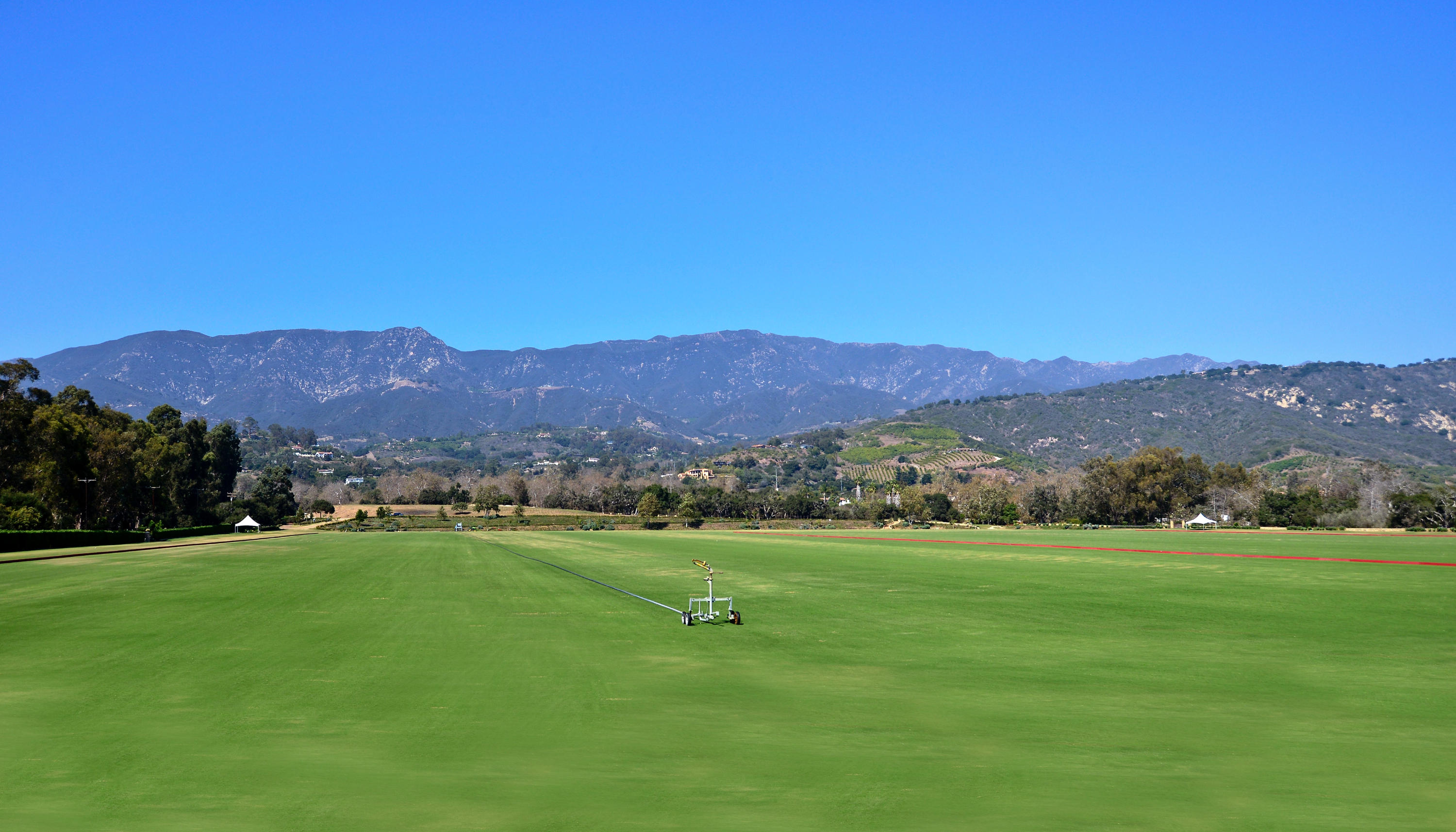 200 Lambert Road Carpinteria, CA 93013 - Photo 2 of 25 a view of a grassy field with mountains in the background