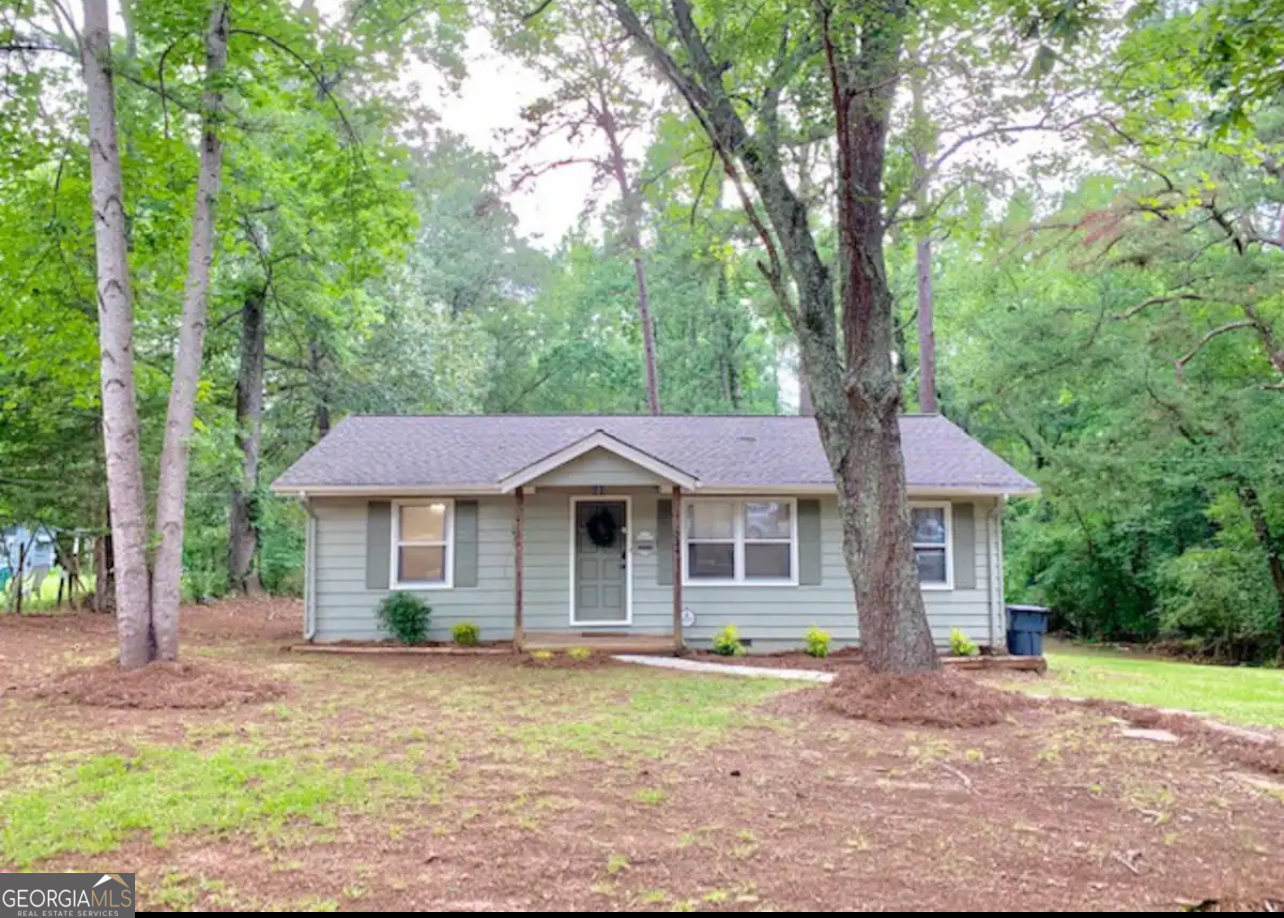 234 Malier Road Hampton, GA 30228 - Photo 1 of 1 a front view of a house with a garden and porch