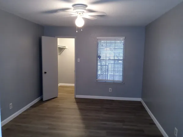 a view of walk in closet with empty racks