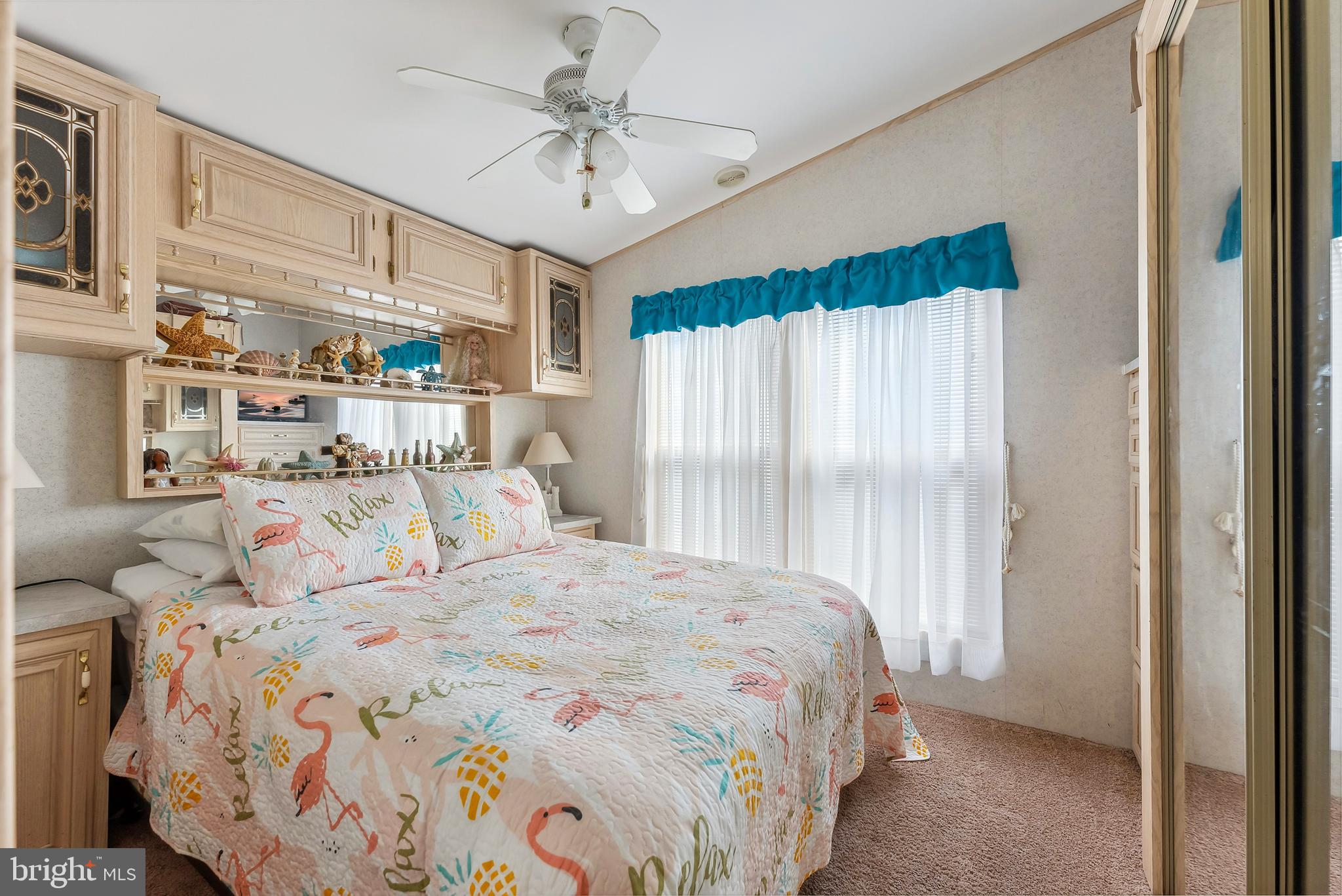 169 Edson, Unit 169 Woodbine, NJ 08270 - Photo 13 of 45 a bedroom with a large bed and a chandelier