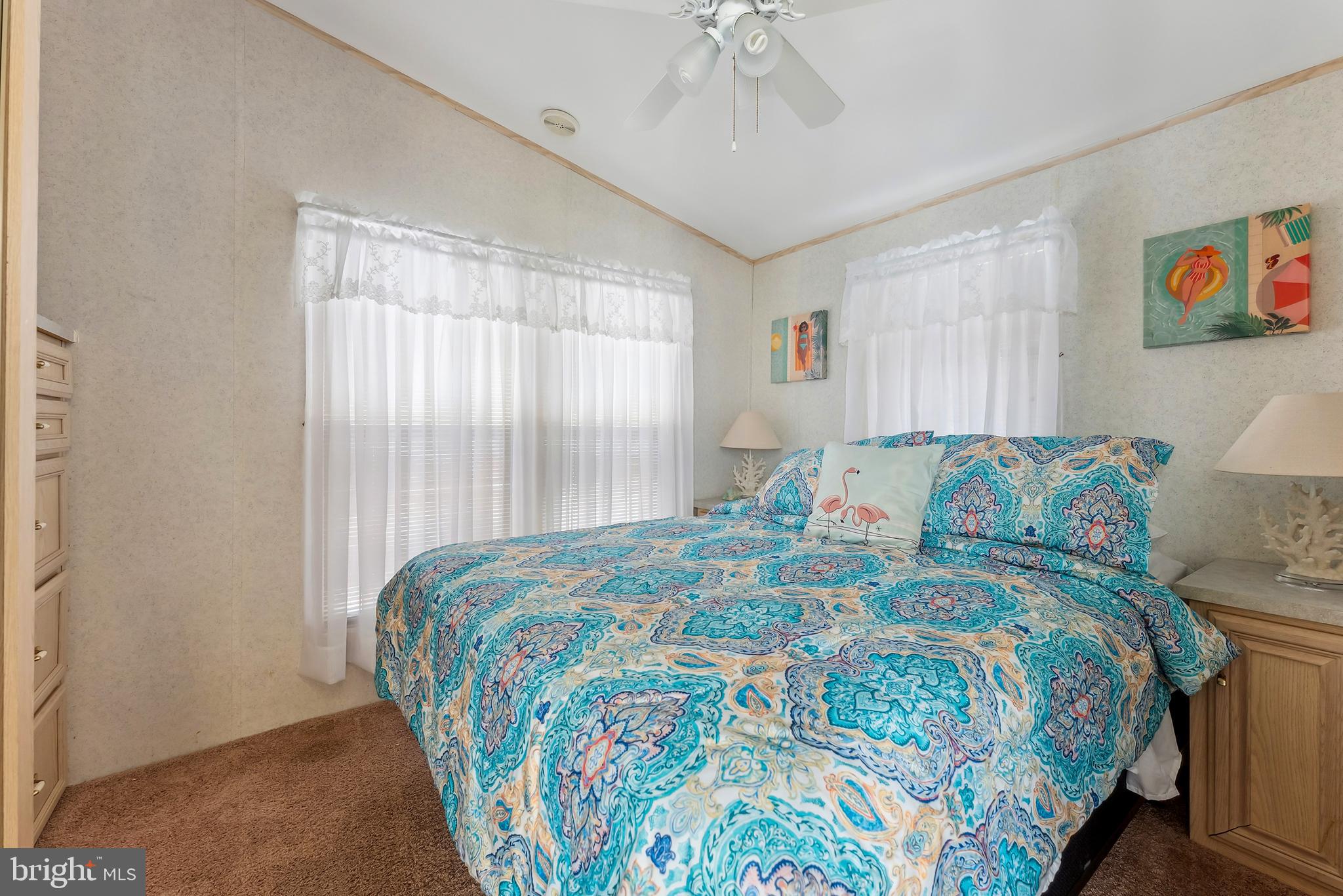169 Edson, Unit 169 Woodbine, NJ 08270 - Photo 16 of 45 a bedroom with a bed and a chandelier