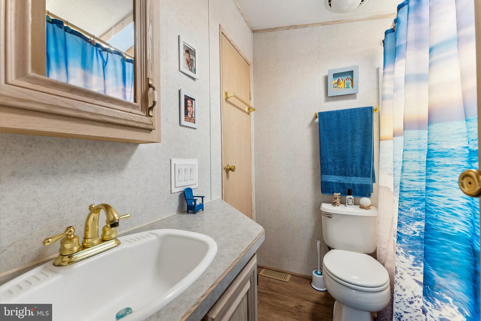 169 Edson, Unit 169 Woodbine, NJ 08270 - Photo 18 of 45 a bathroom with a granite countertop toilet sink and mirror