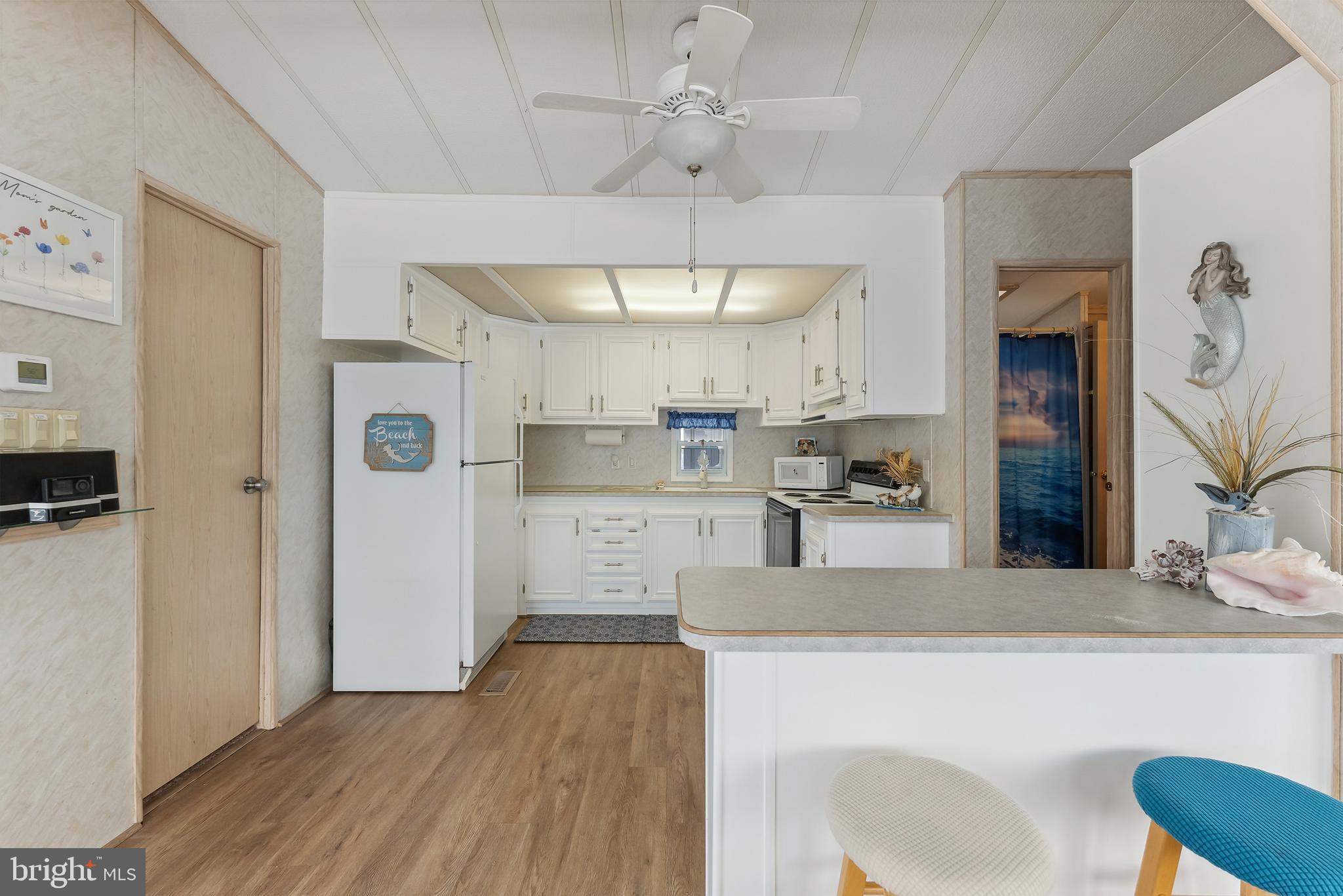 169 Edson, Unit 169 Woodbine, NJ 08270 - Photo 2 of 45 a large kitchen with cabinets wooden floor and stainless steel appliances