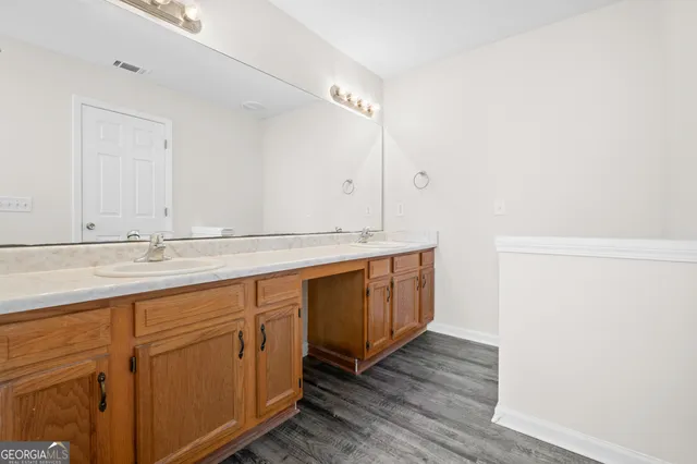 a bathroom with a double vanity sink and mirror