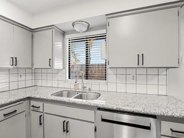 a kitchen with a sink and cabinets