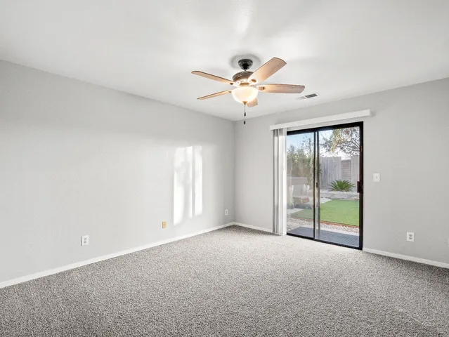 a view of a livingroom with a ceiling fan and window
