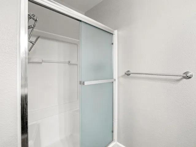 a view of walk in closet with empty racks