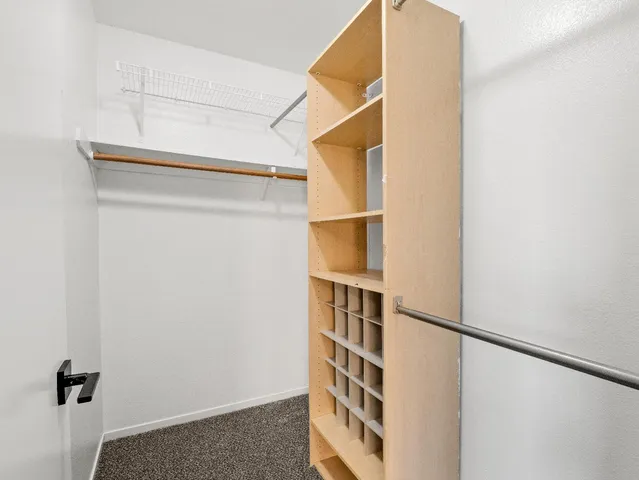 a view of a patio with table and chairs with wooden floor and fence