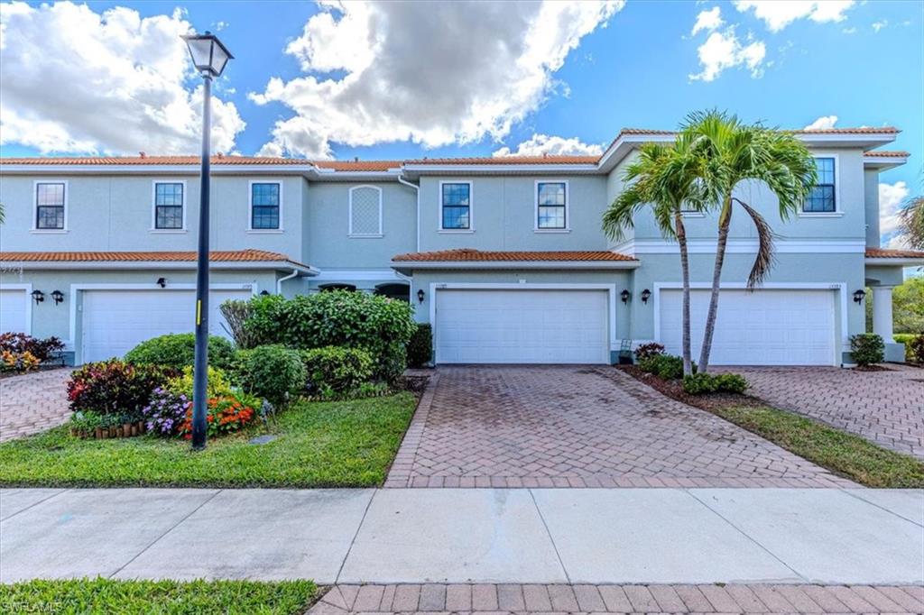 15389 Summit Pl Circle, Unit 286 Naples, FL 34119 - Photo 1 of 29 Mediterranean / spanish-style house with decorative driveway, a garage, stucco siding, and a tile roof