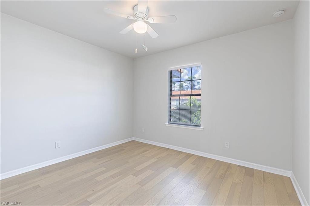 15389 Summit Pl Circle, Unit 286 Naples, FL 34119 - Photo 16 of 29 Empty room with light wood-style flooring and a ceiling fan