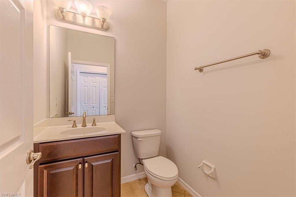15389 Summit Pl Circle, Unit 286 Naples, FL 34119 - Photo 17 of 29 Half bathroom featuring vanity and light tile patterned floors