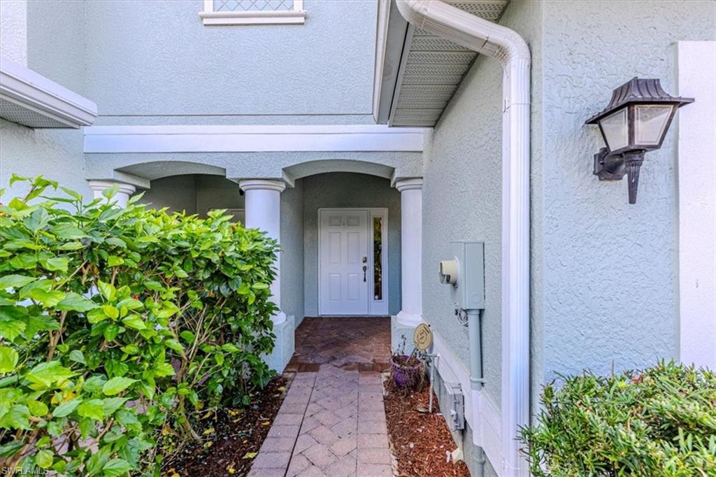 15389 Summit Pl Circle, Unit 286 Naples, FL 34119 - Photo 2 of 29 Property entrance featuring stucco siding