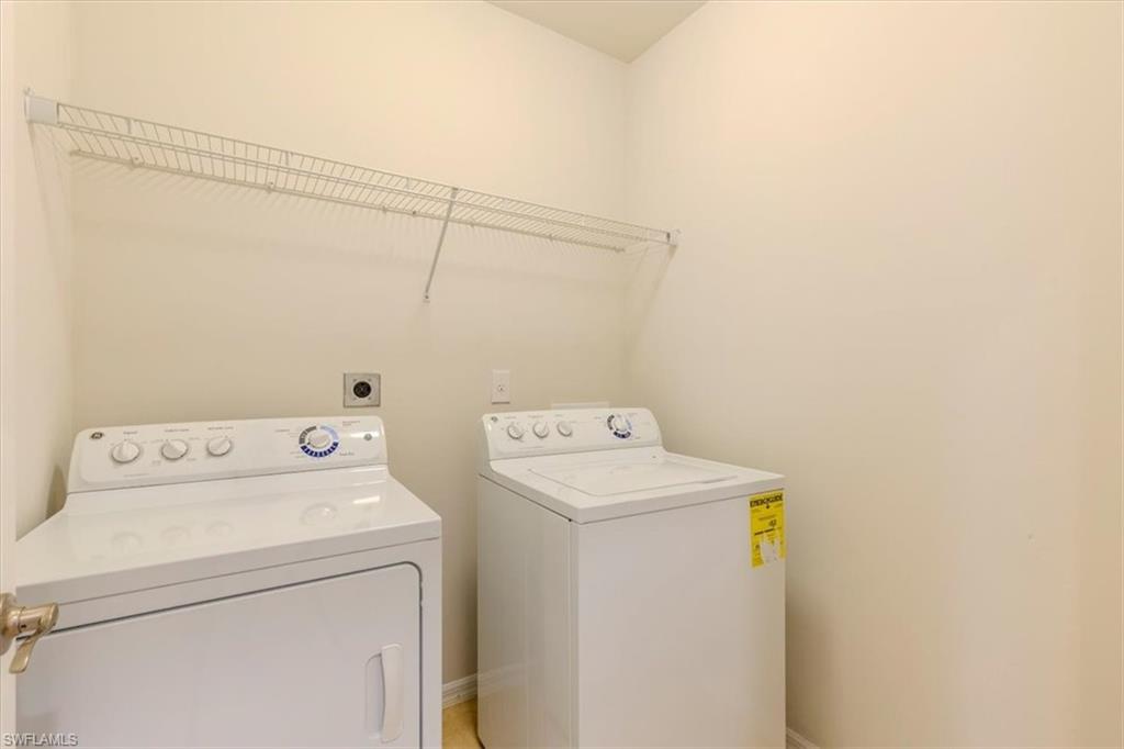 15389 Summit Pl Circle, Unit 286 Naples, FL 34119 - Photo 23 of 29 Laundry area with separate washer and dryer and baseboards
