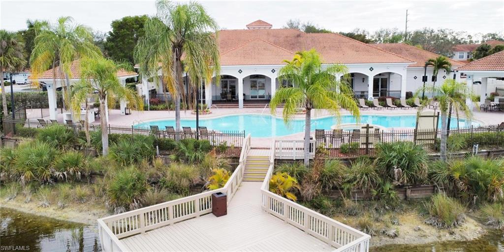 15389 Summit Pl Circle, Unit 286 Naples, FL 34119 - Photo 28 of 29 Community pool with a water view and a patio area