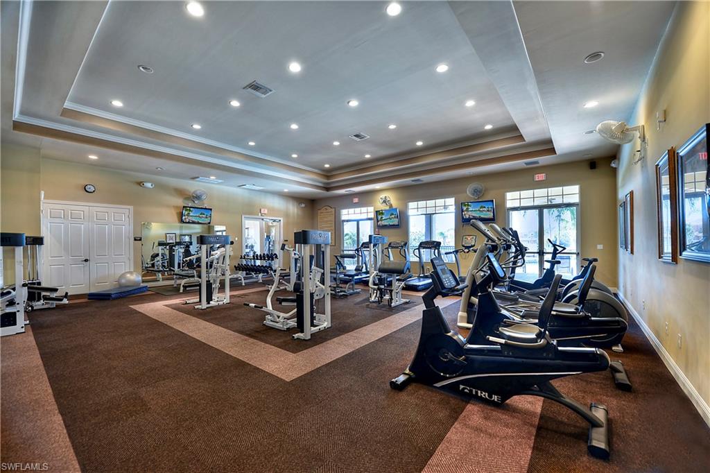 15389 Summit Pl Circle, Unit 286 Naples, FL 34119 - Photo 29 of 29 Gym with a tray ceiling and recessed lighting